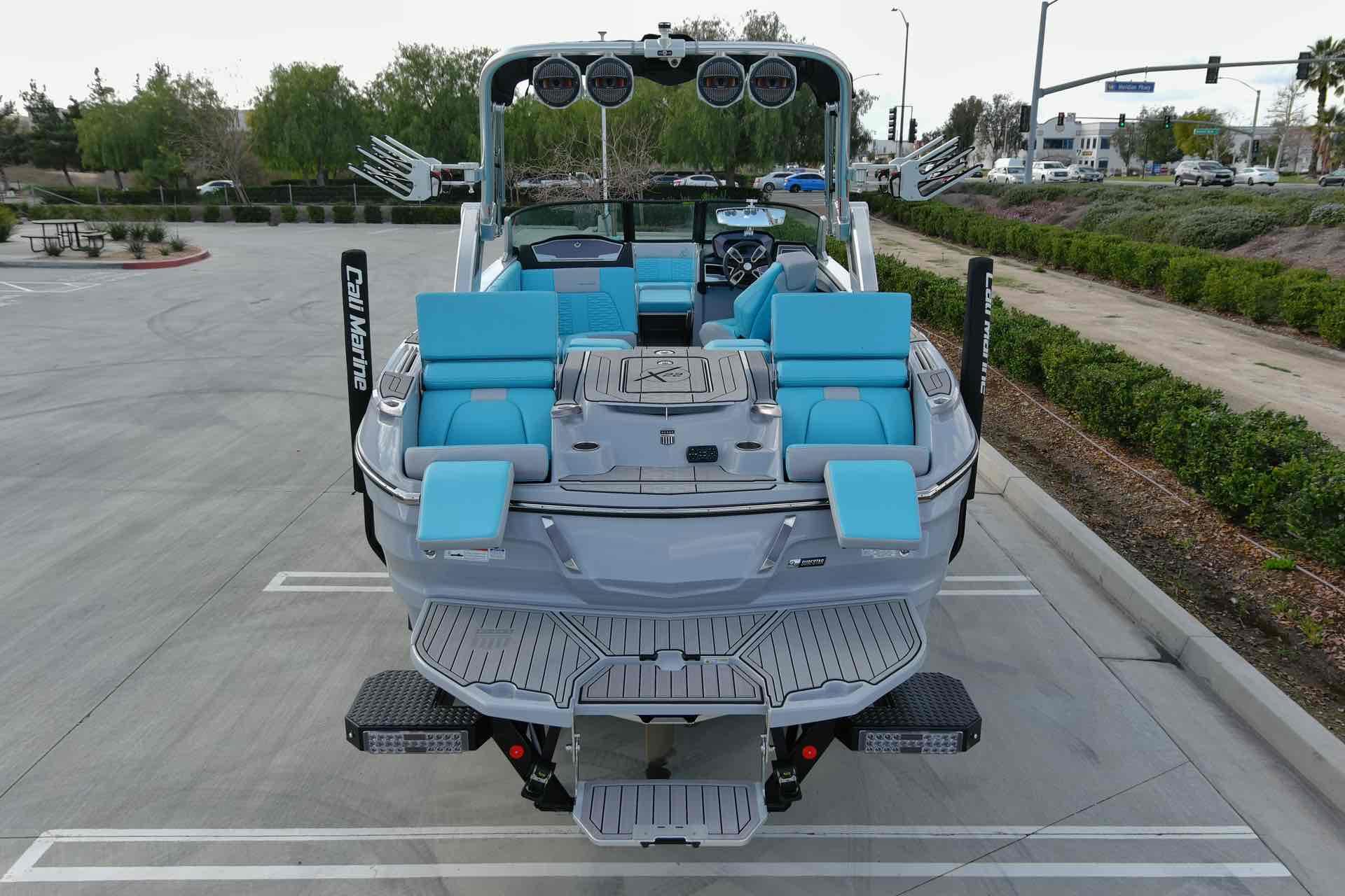 Slide: The Image of 2023 MasterCraft X22 boat with blue seating and advanced audio system. - 5