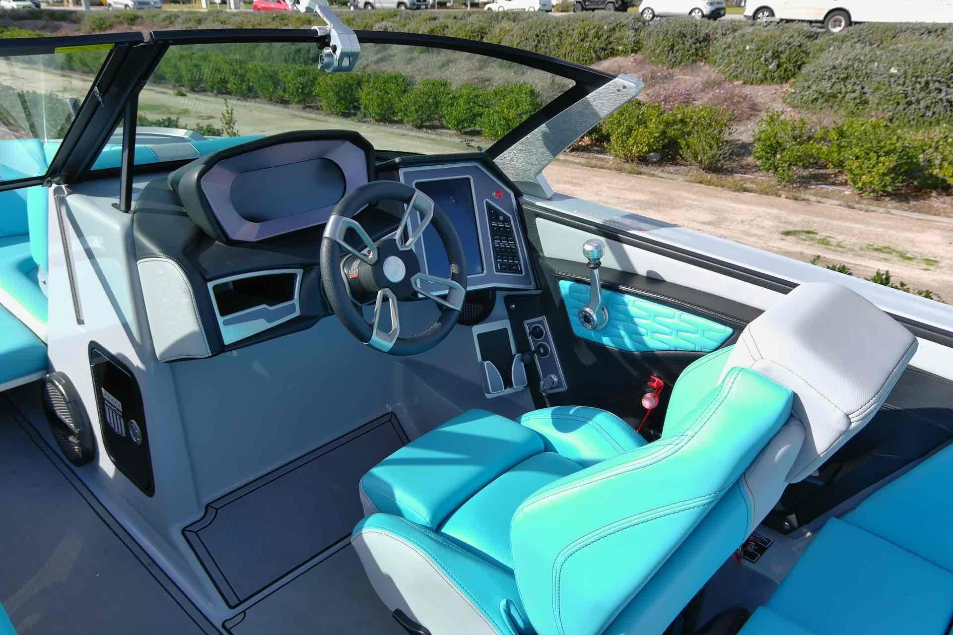 Slide: The Image of 2023 MasterCraft X22 boat interior with modern dashboard and turquoise seating. - 7