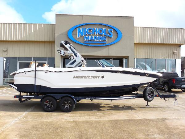 Slide: The Image of 2024 MasterCraft X24 boat on trailer at Nichols Marine dealership. - 1