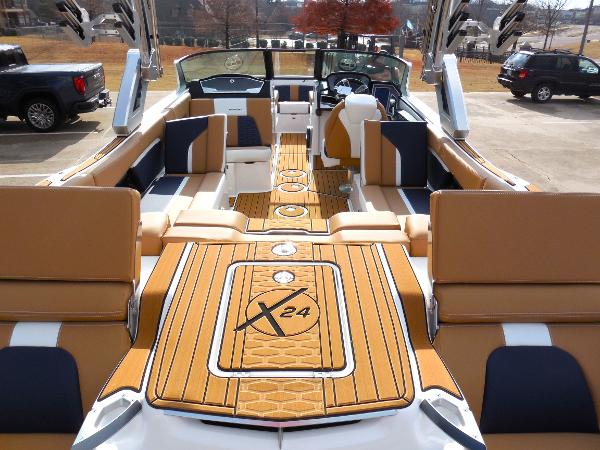 Slide: The Image of 2024 MasterCraft X24 boat interior with luxurious seating and teak flooring. - 5