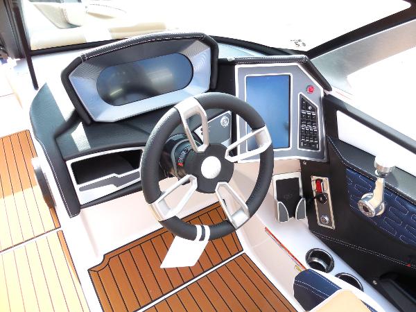 Slide: The Image of 2024 MasterCraft X24 boat dashboard with modern steering wheel and digital controls. - 7