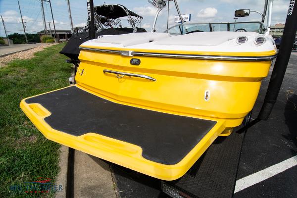 Slide: The Image of 2005 MasterCraft X45 boat with yellow exterior and swim platform. - 10