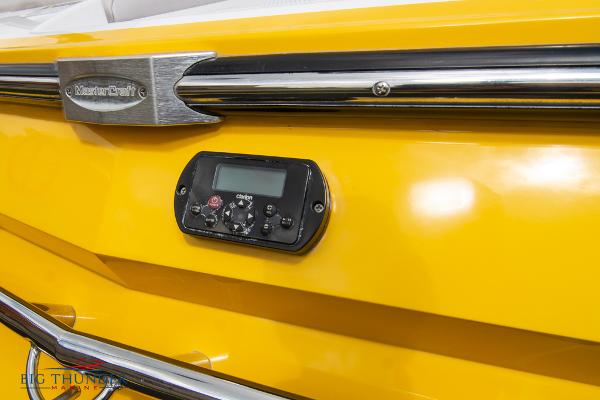 Slide: The Image of 2005 MasterCraft X45 boat, yellow exterior with control panel and chrome accents. - 11