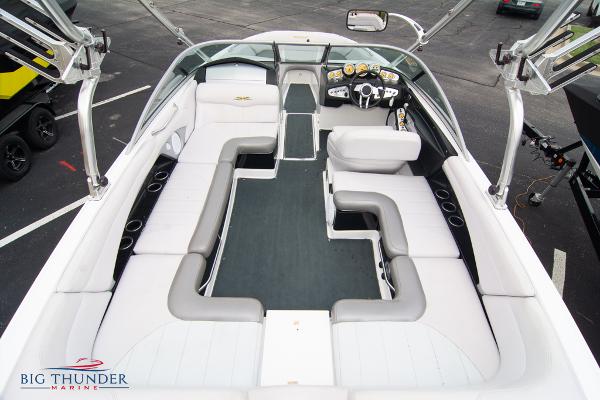 Slide: The Image of 2005 MasterCraft X45 boat interior with white and gray seating, steering console, and Big Thunder Marine logo. - 14