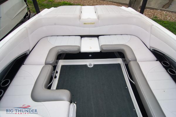 Slide: The Image of 2005 MasterCraft X45 boat interior with white and gray seating, Big Thunder Marine logo. - 19