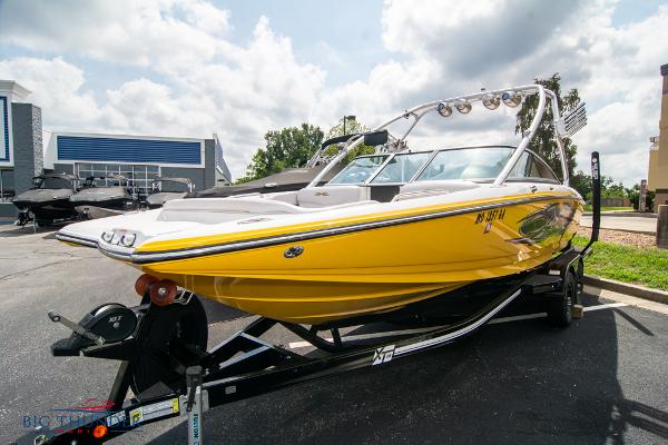Slide: The Image of 2005 MasterCraft X45 yellow boat on trailer in parking lot. - 2