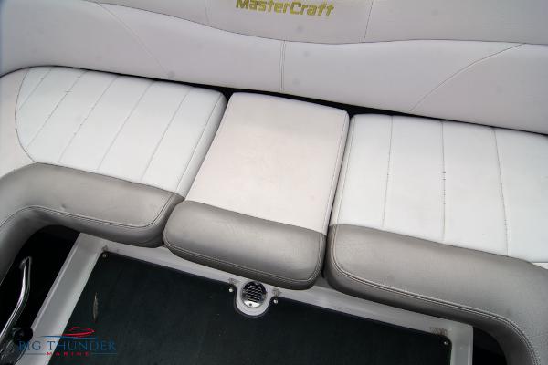 Slide: The Image of 2005 MasterCraft X45 boat interior seating with white and gray upholstery. - 21