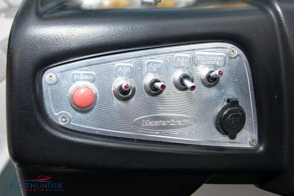Slide: The Image of Control panel of a 2005 MasterCraft X45 boat with switches and a horn button. - 28