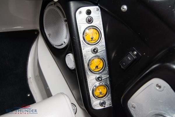 Slide: The Image of 2005 MasterCraft X45 boat dashboard with yellow gauges and speaker. - 30
