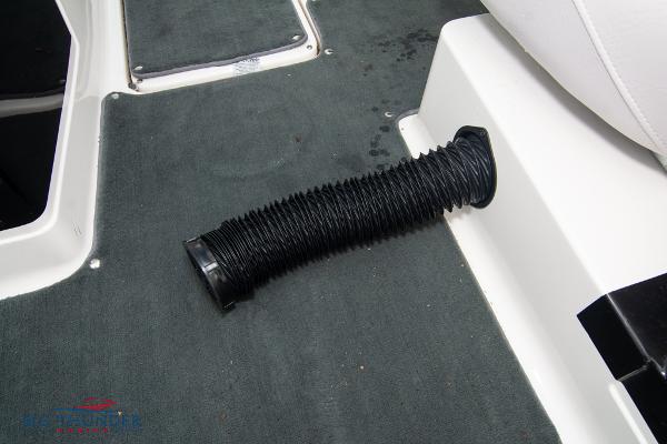 Slide: The Image of 2005 MasterCraft X45 interior with black flexible hose on grey carpet. - 38