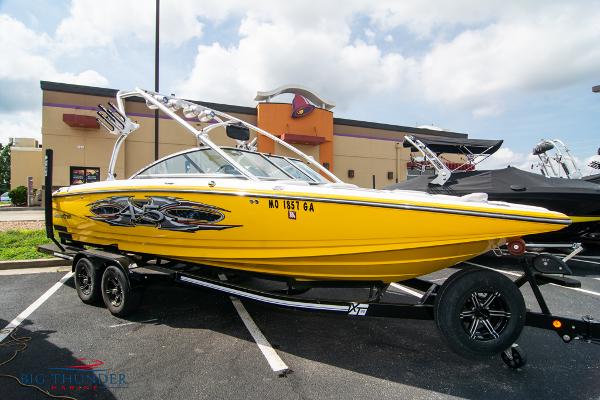 Slide: The Image of 2005 MasterCraft X45 yellow boat on trailer in parking lot. - 4