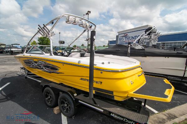 Slide: The Image of 2005 MasterCraft X45 yellow boat on trailer at Big Thunder Marine dealership. - 5