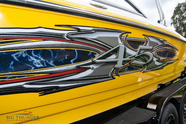 Slide: The Image of 2005 MasterCraft X45 boat with vibrant yellow and custom graphics. - 6