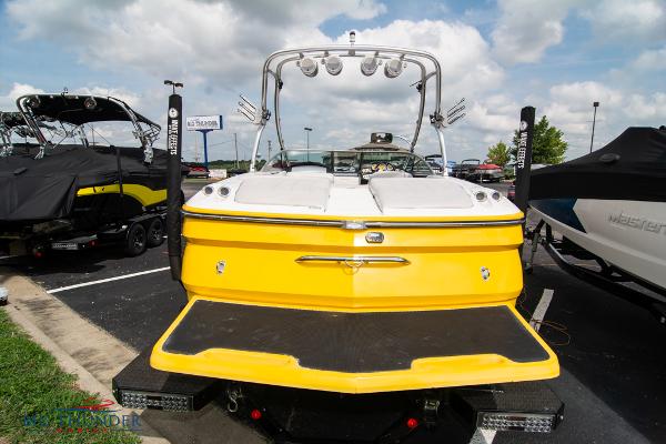Slide: The Image of 2005 MasterCraft X45 boat, yellow and white, rear view in a parking lot. - 7
