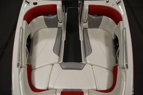 Slide: The Image of 2013 MasterCraft X55 boat interior with white and red seating. - 12