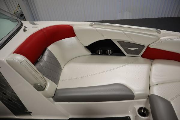 Slide: The Image of 2013 MasterCraft X55 boat interior with red, white, and gray seating. - 14