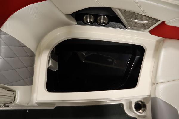 Slide: The Image of Interior storage compartment of a 2013 MasterCraft X55 boat with cup holders. - 16