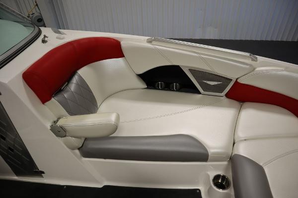 Slide: The Image of 2013 MasterCraft X55 boat interior with red, white, and gray seating. - 17