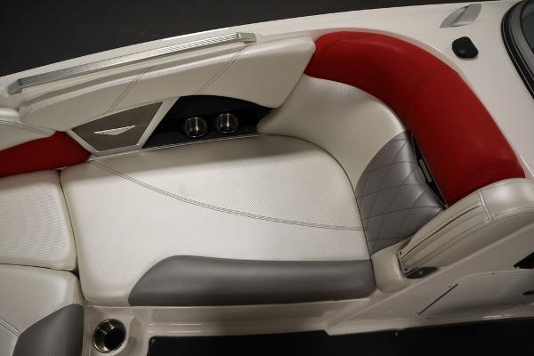 Slide: The Image of 2013 MasterCraft X55 boat interior with white, red, and gray seating. - 21