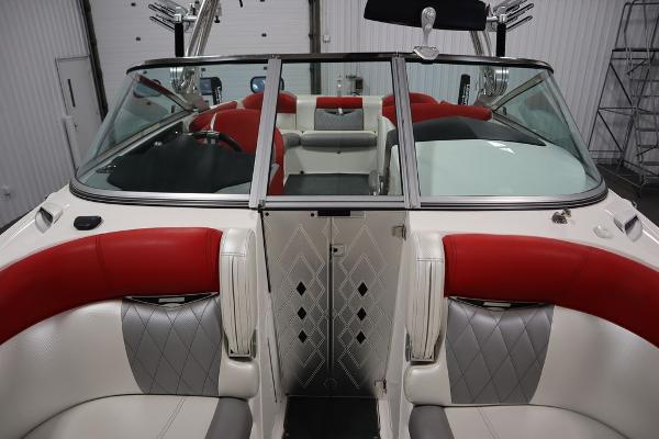 Slide: The Image of 2013 MasterCraft X55 boat interior with red, white, and gray seating. - 24