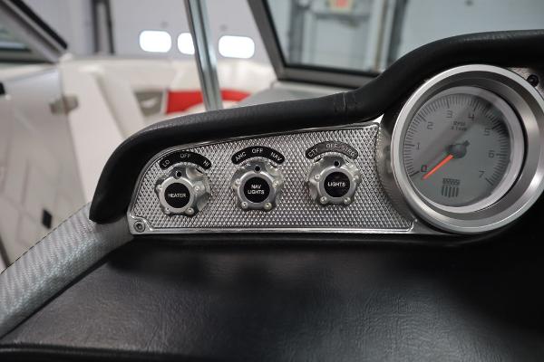 Slide: The Image of 2013 MasterCraft X55 boat dashboard with heater, navigation lights, and gauge. - 27