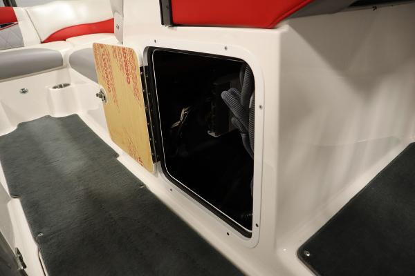 Slide: The Image of 2013 MasterCraft X55 boat interior storage compartment with open door. - 28