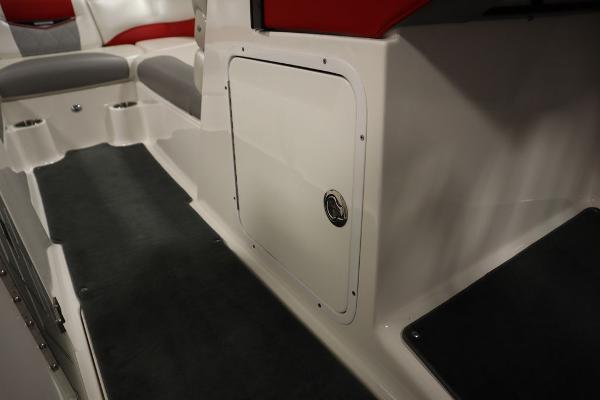 Slide: The Image of 2013 MasterCraft X55 boat interior with storage compartment and seating. - 29
