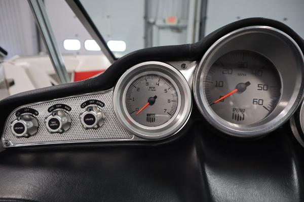 Slide: The Image of 2013 MasterCraft X55 boat dashboard with speedometer and control switches. - 31