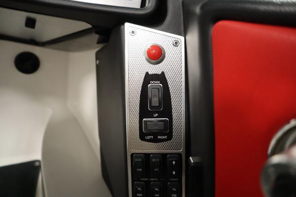 Slide: The Image of Control panel of a 2013 MasterCraft X55 boat with red and black buttons. - 38