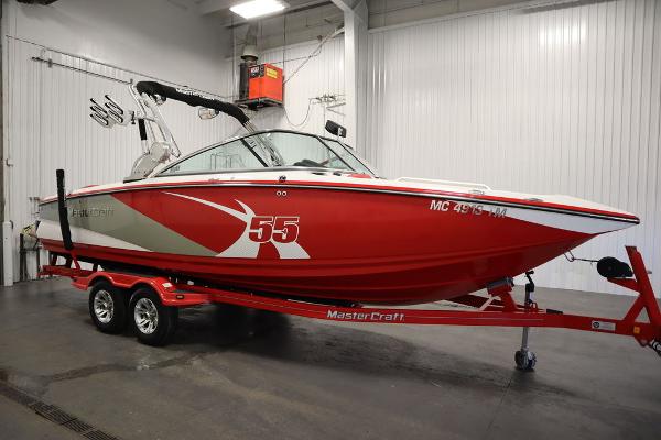Slide: The Image of 2013 MasterCraft X55 red and white boat on trailer in indoor storage. - 4