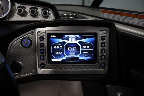 Slide: The Image of 2013 MasterCraft X55 boat dashboard with digital display and controls. - 41