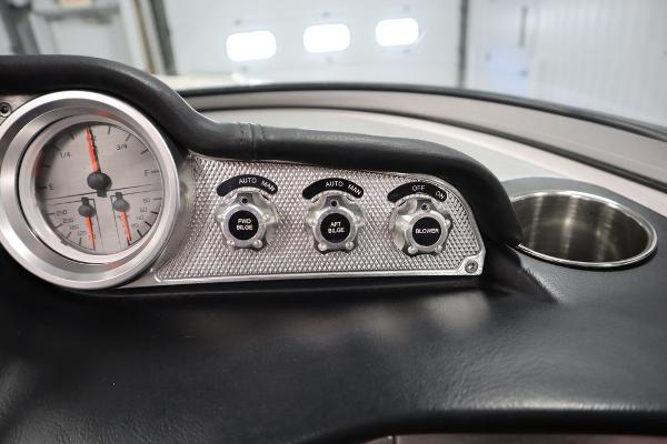 Slide: The Image of Close-up of 2013 MasterCraft X55 boat dashboard controls and gauge. - 43