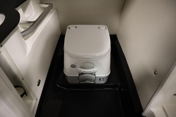 Slide: The Image of 2013 MasterCraft X55 boat interior with portable toilet. - 48