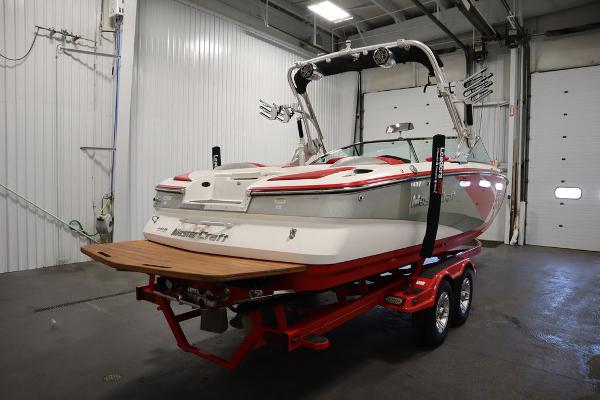 Slide: The Image of 2013 MasterCraft X55 boat on a red trailer in a garage. - 5