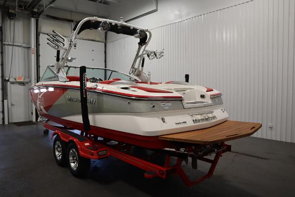 Slide: The Image of 2013 MasterCraft X55 boat on a red trailer in a storage facility. - 6