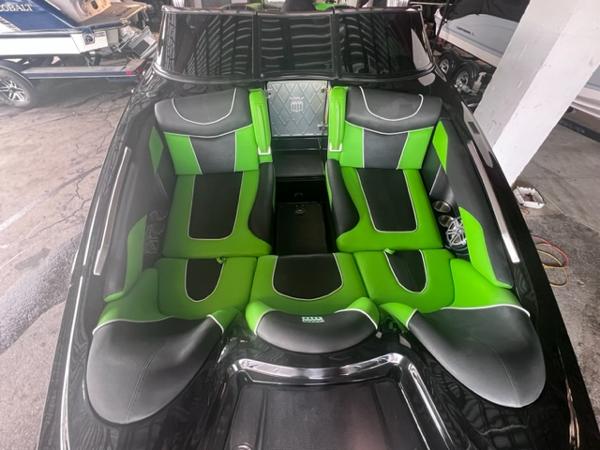 Slide: The Image of 2013 MasterCraft XStar boat interior with green and black seating. - 10