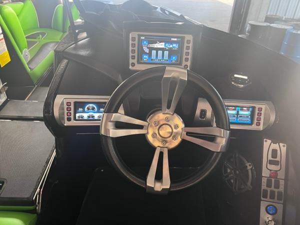 Slide: The Image of 2013 MasterCraft XStar boat dashboard with advanced controls and touchscreen displays. - 14