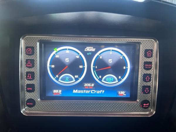 Slide: The Image of MasterCraft XStar 2013 dashboard display showing speed and RPM gauges. - 17