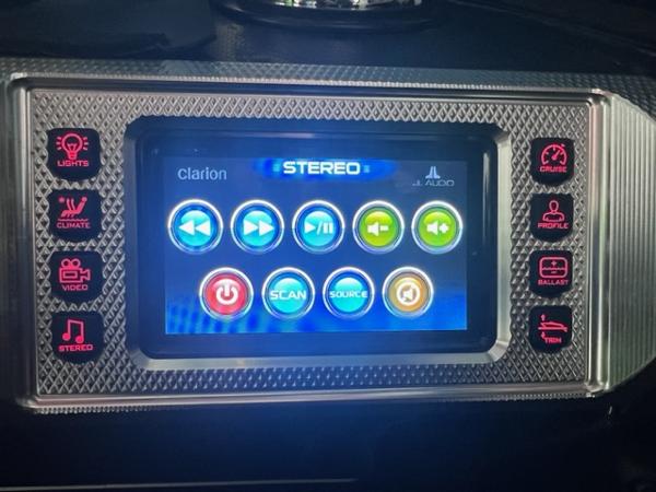 Slide: The Image of 2013 MasterCraft XStar touchscreen control panel with stereo and system settings. - 25