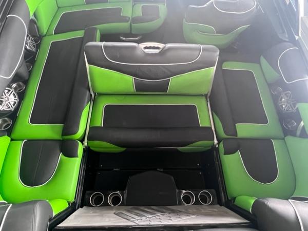 Slide: The Image of 2013 MasterCraft XStar interior with green and black seating. - 31