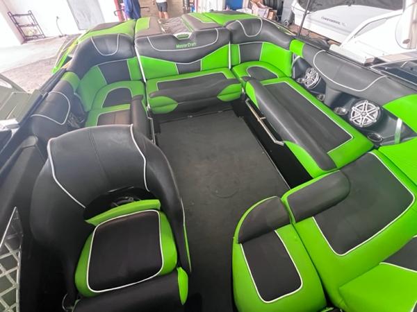 Slide: The Image of 2013 MasterCraft XStar boat interior with green and black seating. - 33