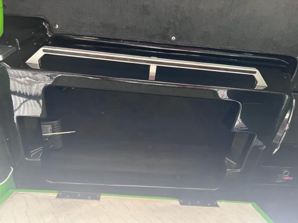 Slide: The Image of 2013 MasterCraft XStar boat storage compartment with black interior. - 37