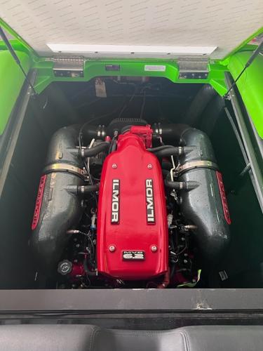 Slide: The Image of 2013 MasterCraft XStar Ilmor engine in green boat. - 38