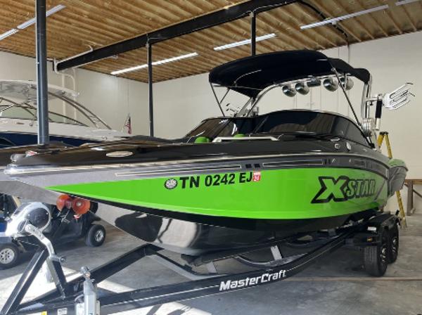 Slide: The Image of 2013 MasterCraft XStar boat in a garage. - 4