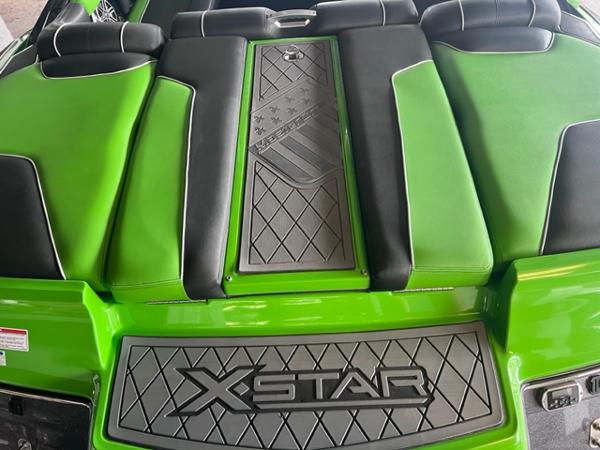 Slide: The Image of 2013 MasterCraft XStar boat with green and black upholstery. - 44