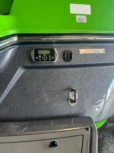 Slide: The Image of Control panel of a 2013 MasterCraft XStar boat with green exterior. - 47