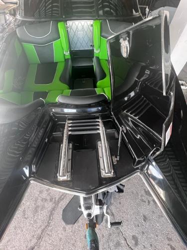 Slide: The Image of 2013 MasterCraft XStar boat with green and black interior, open rear storage compartments. - 7