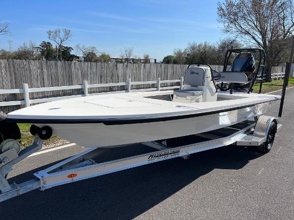 Slide: The Image of 2024 Maverick 18 HPX-V boat on a trailer, parked on a paved road. - 1