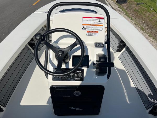 Slide: The Image of 2024 Maverick 18 HPX-V boat console with steering wheel and controls. - 10