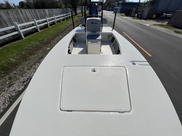 Slide: The Image of 2024 Maverick 18 HPX-V boat on a road, showcasing deck and seating. - 14
